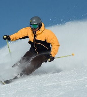 Skier with yellow anorak on the slope