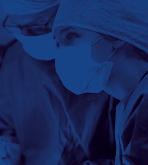 Two surgeons in scrubs with blue filter