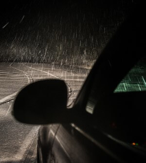 Car driving at night in rain