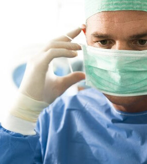 surgeon with mask and gloves preparing for surgery