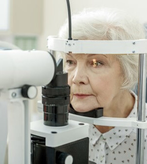 Older woman on chin rest of eye machine